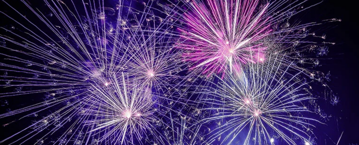 Colorful fireworks exploding in the night sky, symbolizing celebrations.