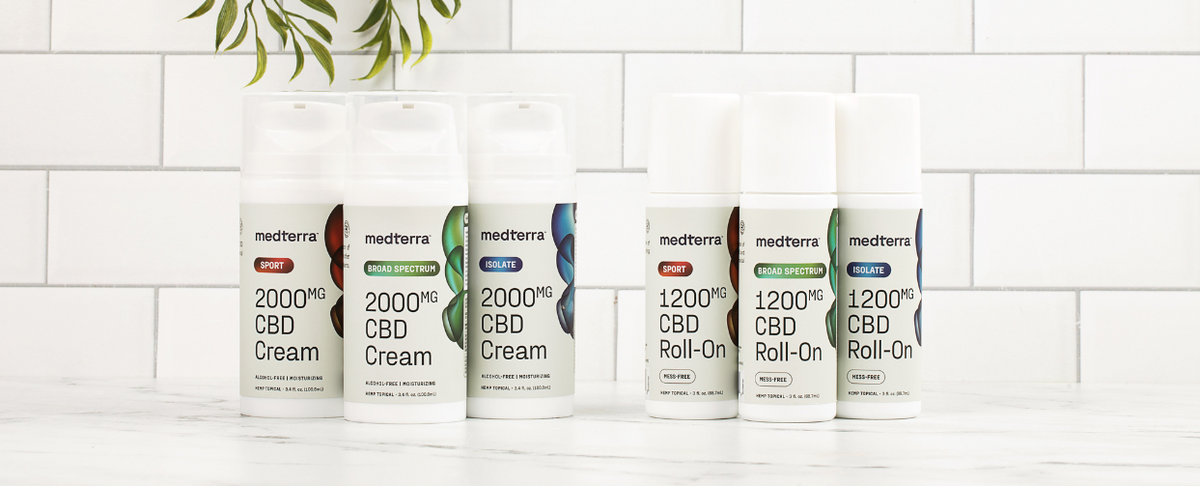 Medterra CBD products including 2000mg CBD Cream and 1200mg CBD Roll-On on a marble surface