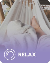 A person is lying in a hammock with a white blanket, viewed from the perspective of their feet. The word "RELAX" and a circular symbol are overlaid at the bottom of the image with a purple gradient background.