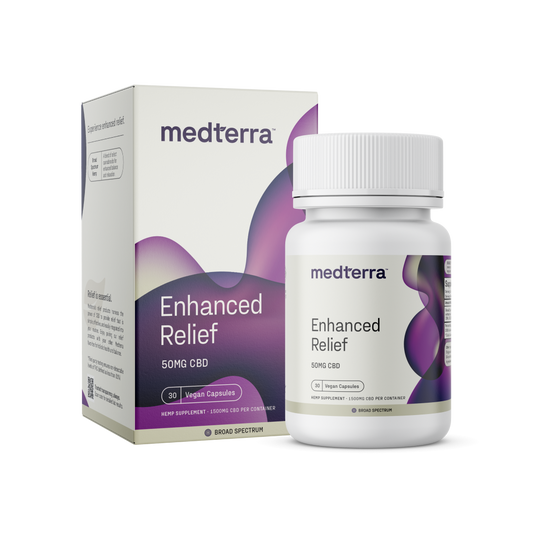 A box and bottle of Medterra Enhanced Relief Broad Spectrum Capsules featuring a purple and white design, emphasizing "50mg Broad Spectrum CBD" and "Vegan Capsules," with 30 capsules per box. The bottle mirrors the details, highlighting the benefits of whole-plant extraction for enhanced relief.