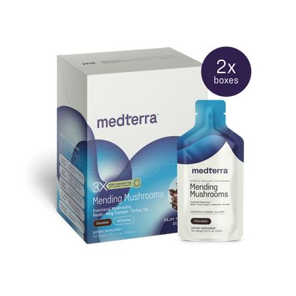 A box and a packet of Medterra Mending Mushrooms dietary supplement. The box highlights its functional mushroom blend, featuring Reishi, King Trumpet, and Turkey Tail for antioxidant benefits. A sticker displays "2x boxes." The packet matches the design and branding of the box.
