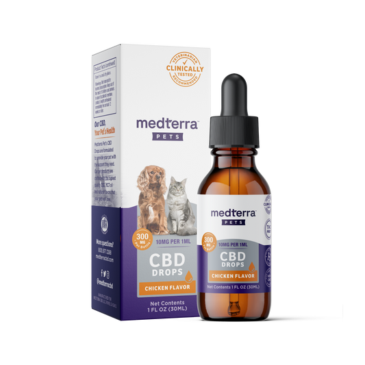 A brown glass dropper bottle labeled "Medterra Pet CBD Drops, Chicken Flavor" is placed in front of its box. The box, featuring images of a dog and a cat, highlights "300mg CBD" and "Clinically Tested." It boasts natural beef and chicken flavorings with organic ingredients. Net contents: 1 fluid ounce (30 mL).