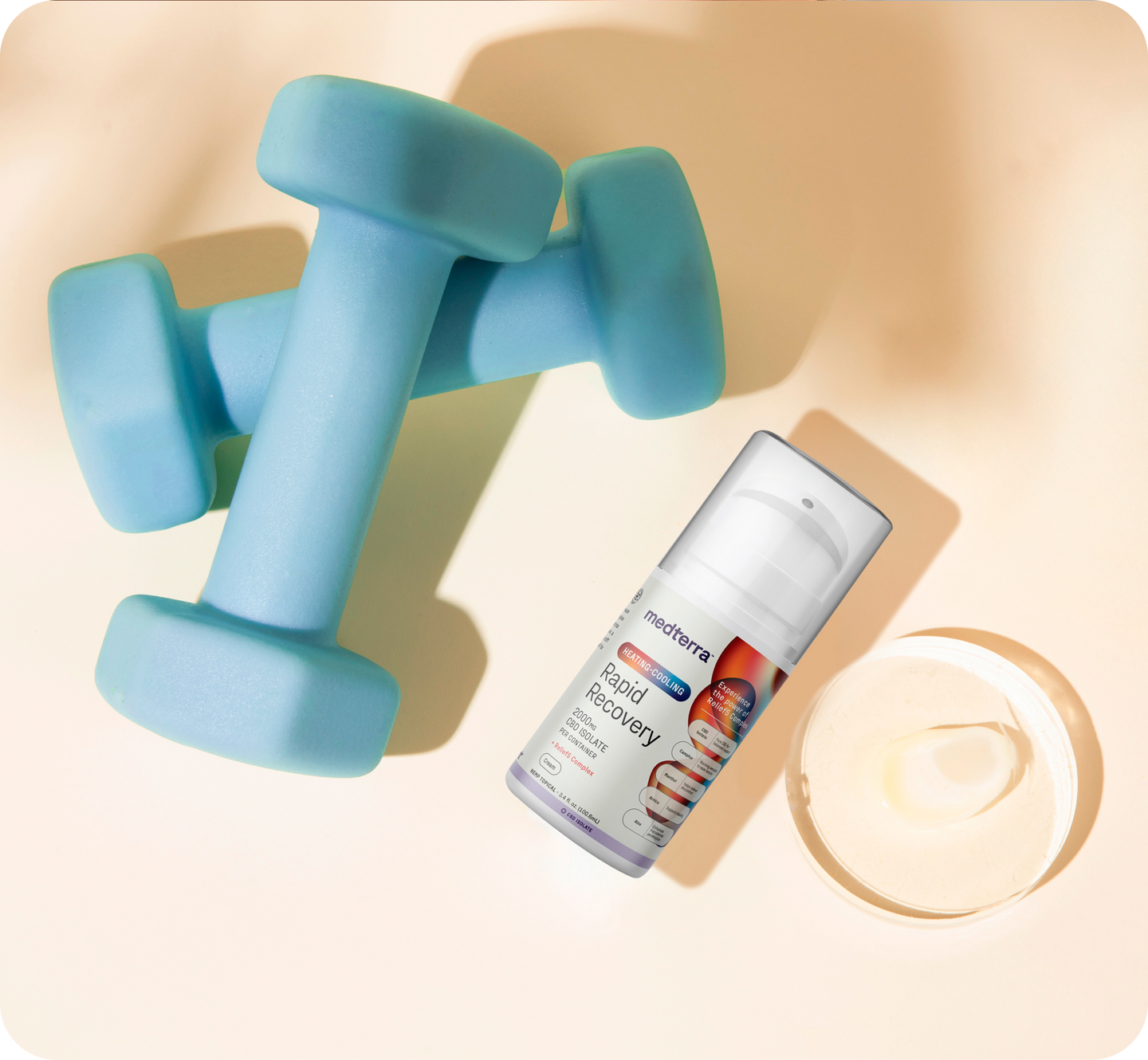 Blue dumbbells with medterra Rapid Recovery pump bottle and open jar of cream on pale background