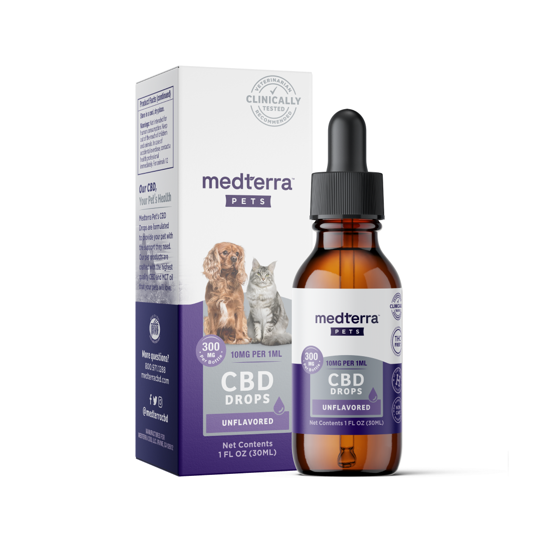 A bottle of Medterra Pet CBD Drops (10mg per 1ml, unflavored) is positioned in front of its box. The packaging features images of a dog and a cat, indicating the product is intended for pets. The box and bottle display dosage information and volume (1 FL OZ/30mL), highlighting its organic ingredients.